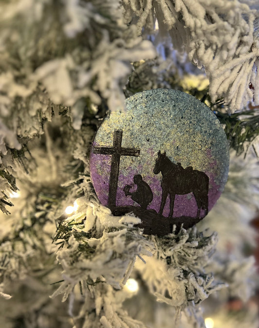 Cowboy kneeling at Cross